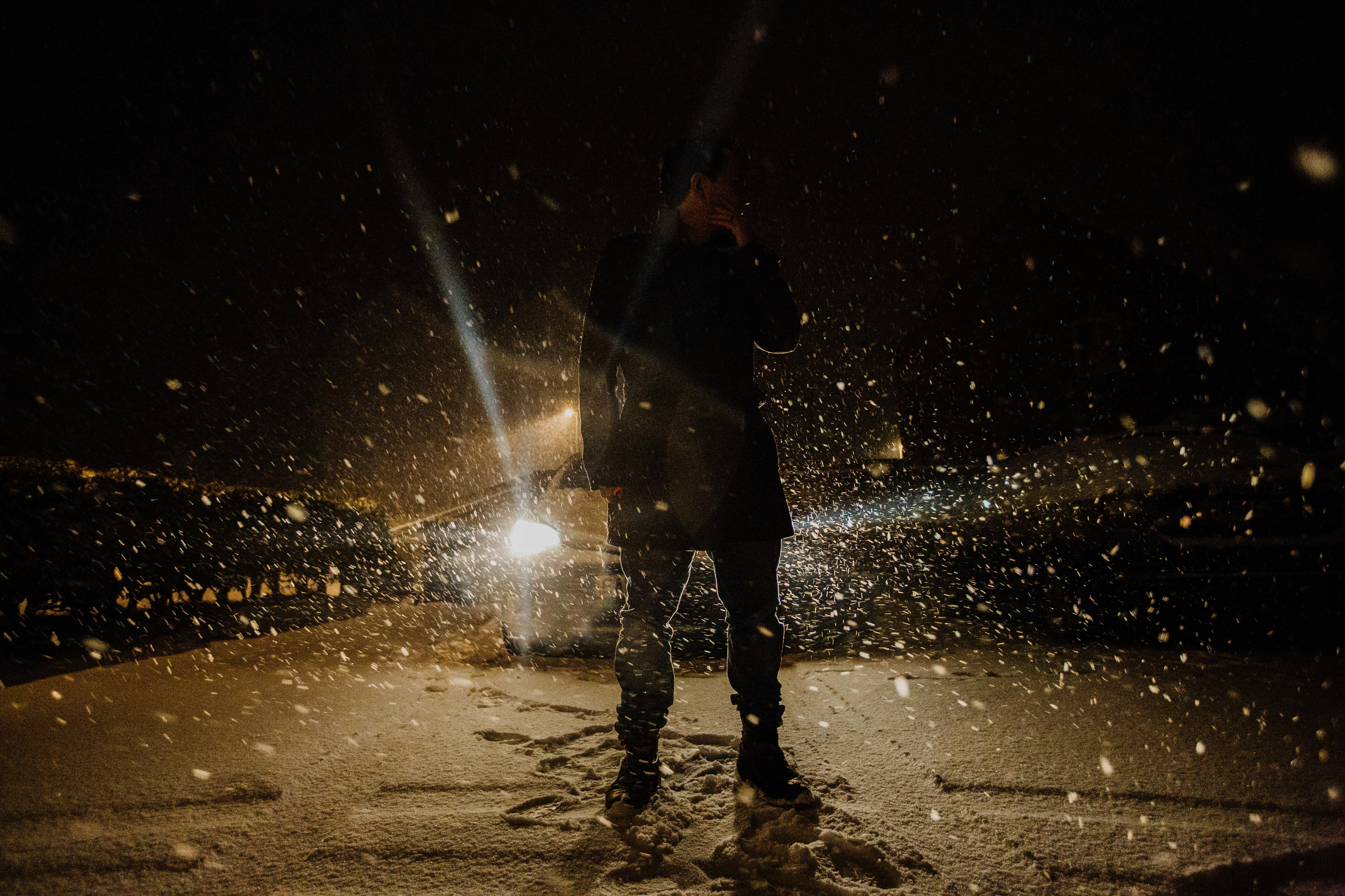 silhouette of person standing on wet ground